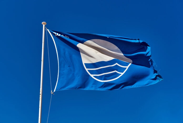 Blue,Flag,Against,Blue,Sky.,Blue,Flag,Is,An,International