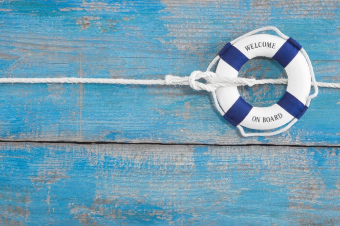 Lifebuoy,Tied,With,A,Rope,-,Blue,Background,For,Cruising