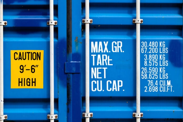 Closeup,Of,Blue,Shipping,Container,With,White,Lettering