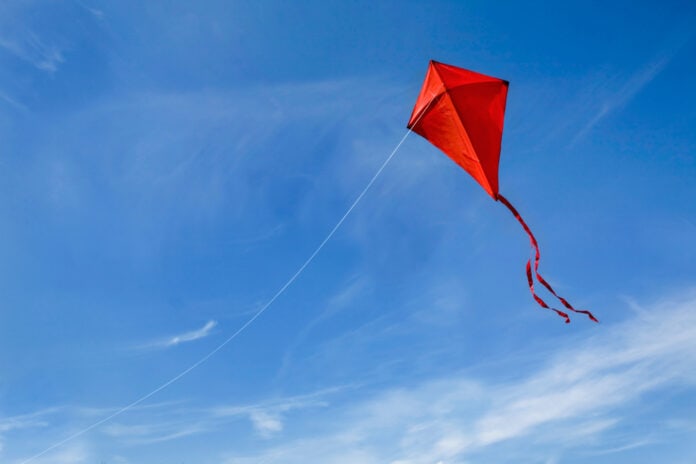 A,Red,Kite,Flying,Against,A,Blue,Sky.