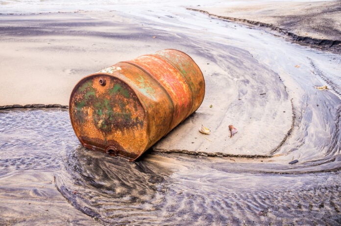 Rusty,Barrel,Oil,On,A,Partly,Black,Coloured,Beach,Illustrates